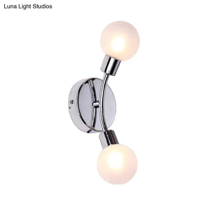 Modern chrome wall lamp with two frosted glass fixture bulbs mounted on a chrome bulb base for bedroom use