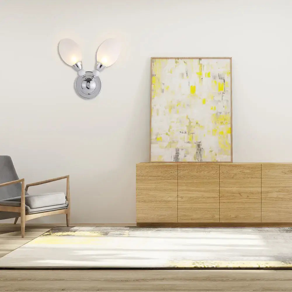 Modern chrome wall light with two frosted white glass shades designed as a bedroom sconce wall light