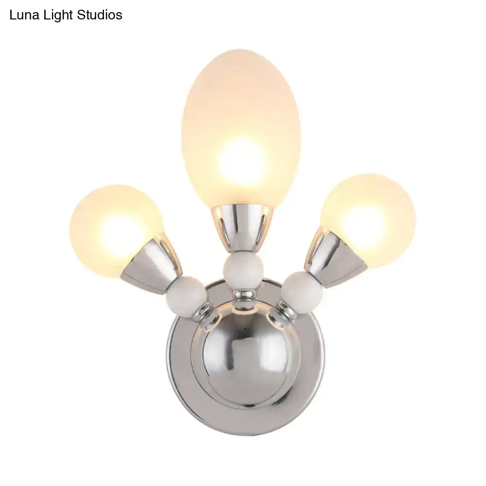 Modern chrome wall light with white glass shades featuring three frosted glass shades and polished metal arms for bedroom use