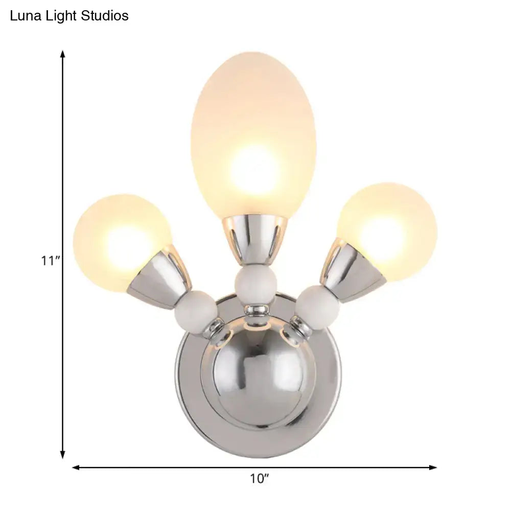 Modern chrome wall light with three frosted white glass globes and white ceramic accents for bedroom sconce lighting