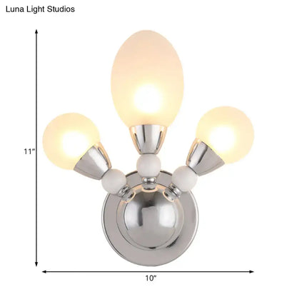 Modern chrome wall light with three frosted white glass globes and white ceramic accents for bedroom sconce lighting