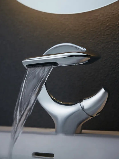 Modern chrome waterfall single handle bathroom faucet with sleek sculptural design for single hole installation