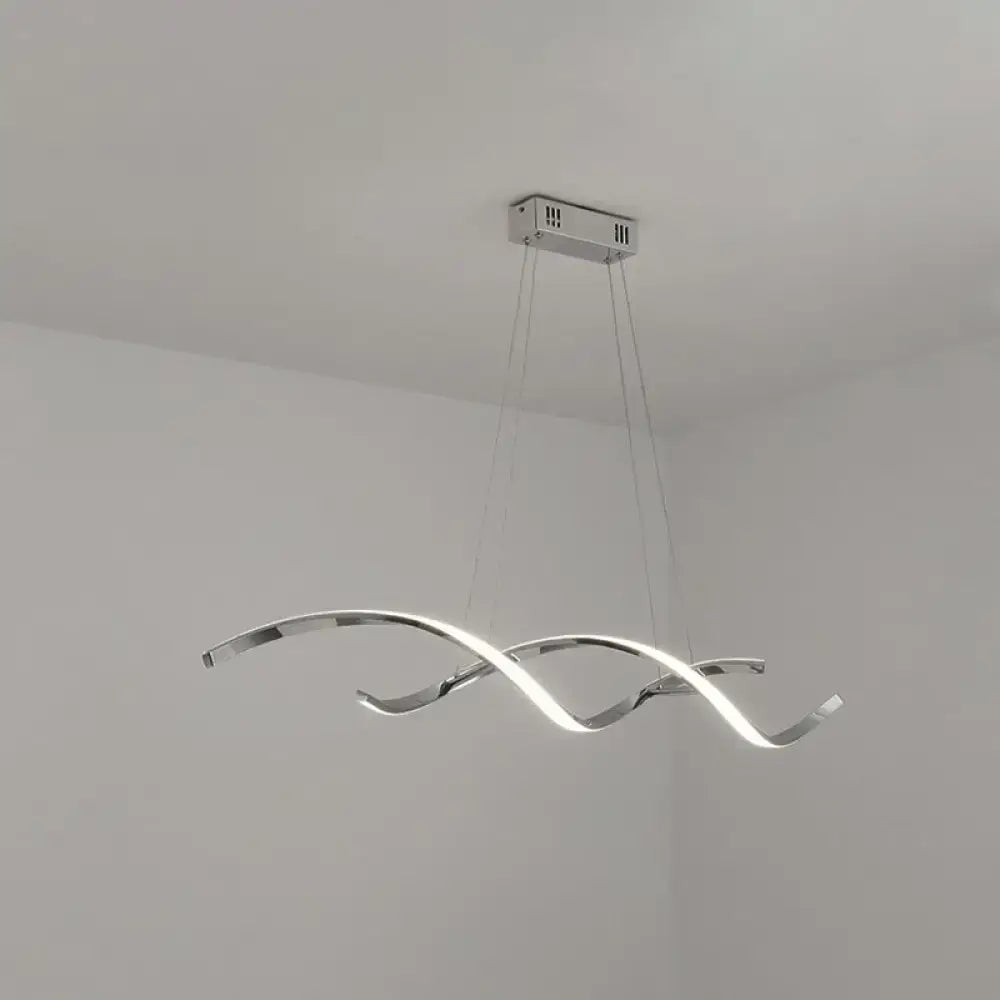 Modern chrome wave LED island lighting with sleek intertwined wave shaped arms emitting bright white light