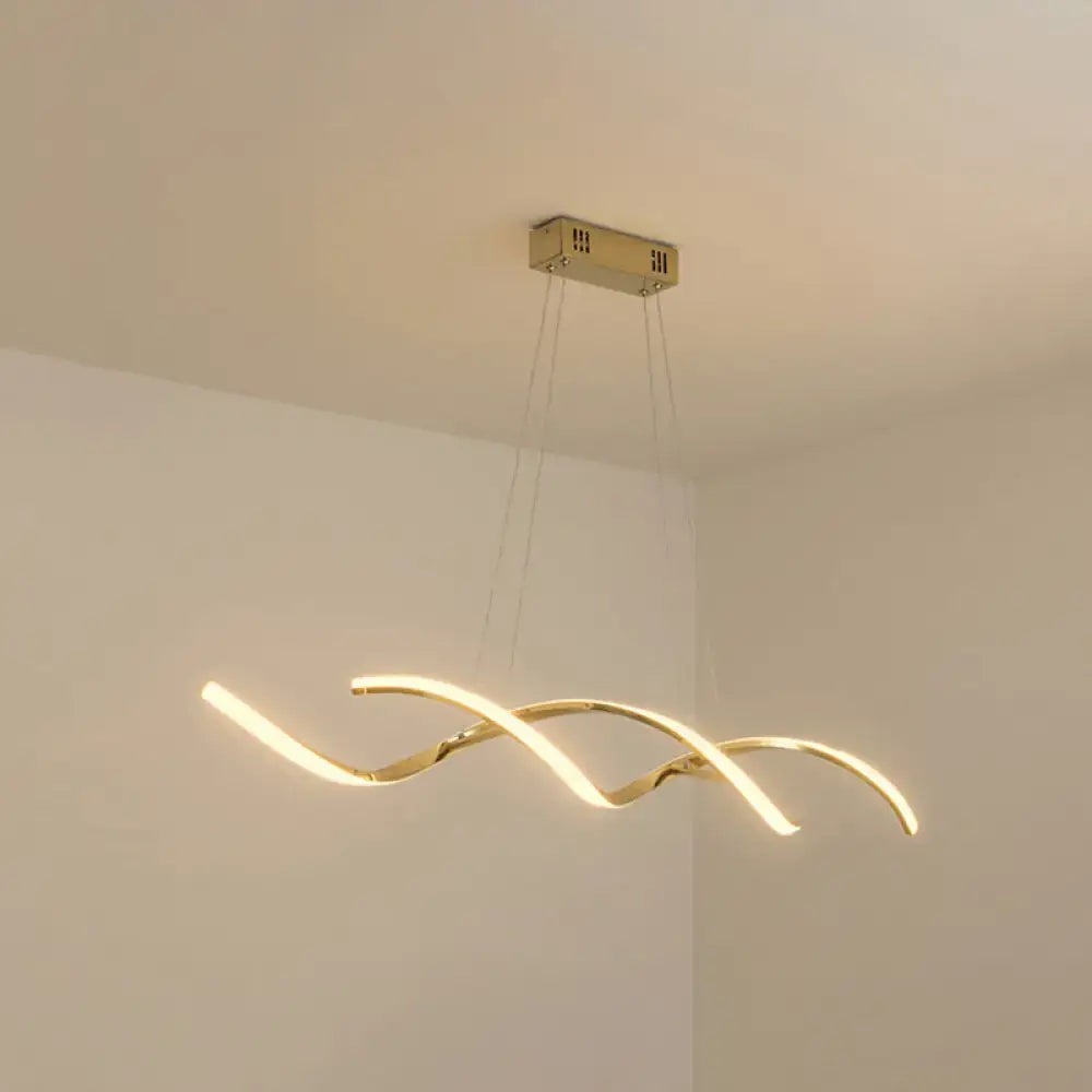Gold-toned modern led island lighting pendant with sleek curved design and three intertwined arms for kitchen use