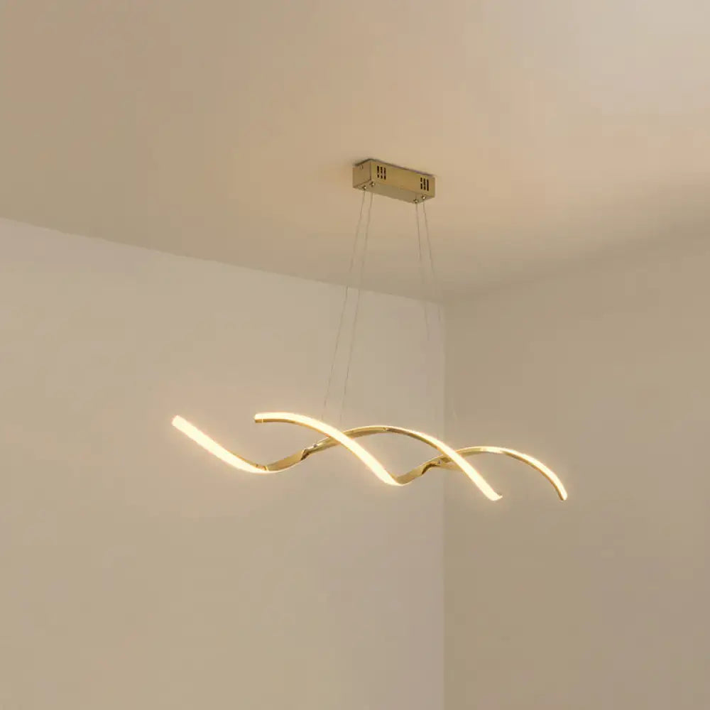 Gold-toned modern led island lighting with a sleek curved design and warm ambient kitchen pendant light illumination