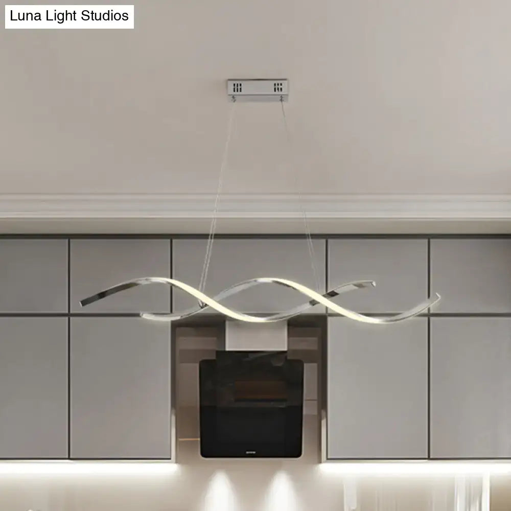 Modern chrome wave led island lighting pendant light in silver tone with sleek flowing design above kitchen cabinetry