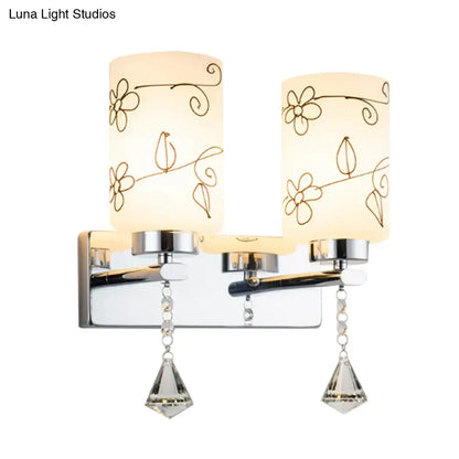 Modern chrome double-light bathroom fixture with white glass cylinder frosted shades and delicate floral etchings