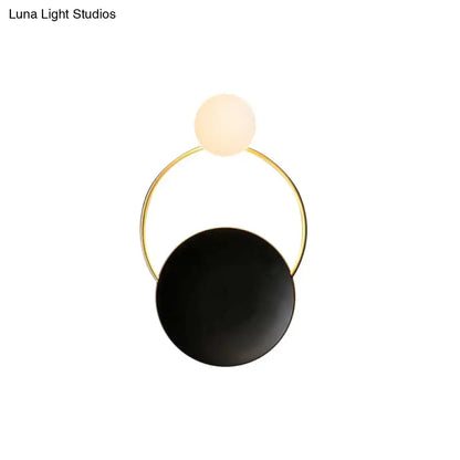 Modern circle wall sconce with sleek gold-toned frame and black and white glass globes for bedroom or corridor lighting