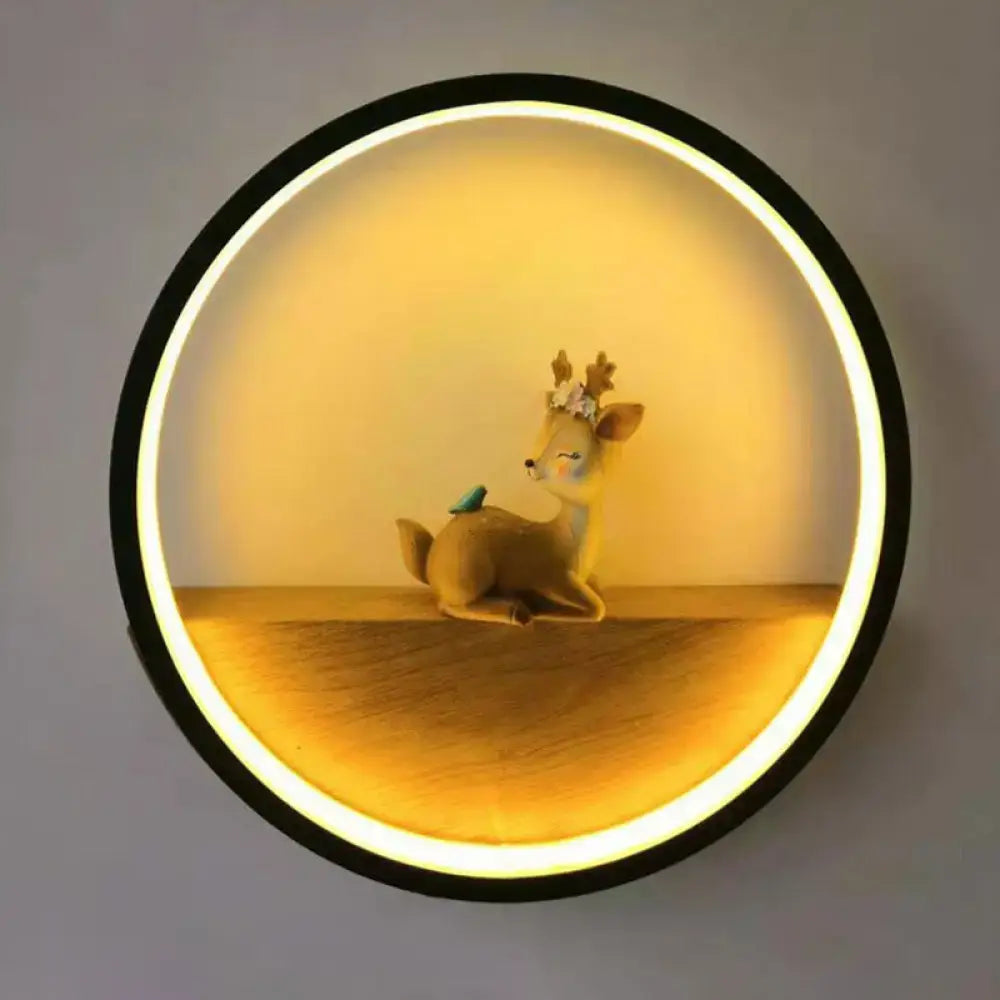 Modern circular black wall light with warm led ring and decorative deer figurine on wooden living room shelf