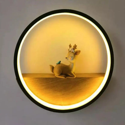 Modern circular black wall light with warm led ring and decorative deer figurine on wooden living room shelf