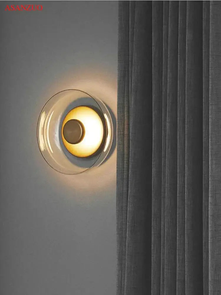 Modern circular glass bowl led wall sconce with clear glass outer ring and warm yellow light for bedroom decorbites decor