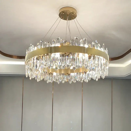 A modern circular gold decorbites crystal chandelier with clear crystal prisms for living room decor