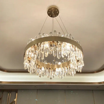 A modern circular gold decorbites crystal chandelier with cascading clear crystal droplets for living room decor