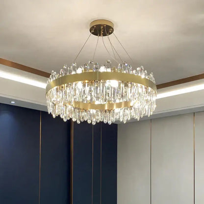 A modern circular gold decorbites crystal chandelier with cascading clear prisms for living room decor