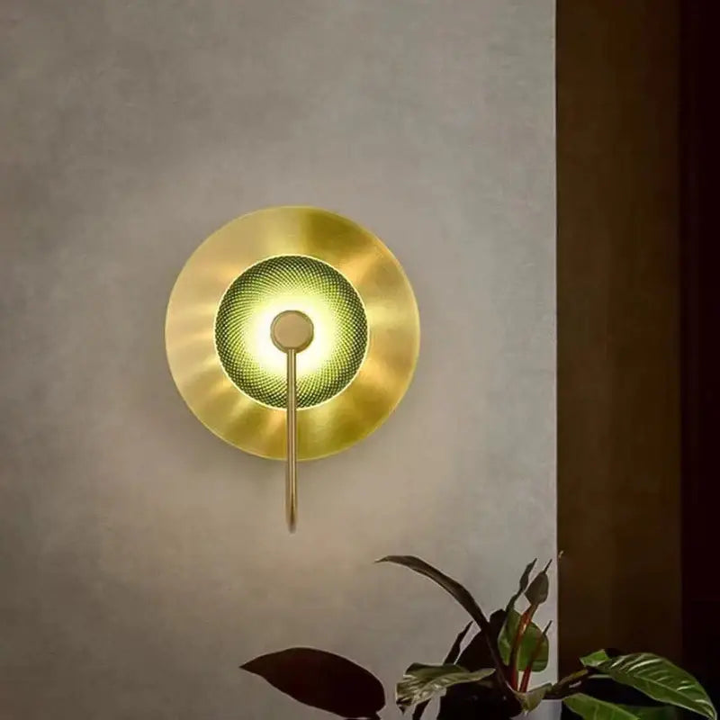 Gold-toned circular green copper wall lamp with textured mesh center and sleek metallic stem for living room decorbites circular green