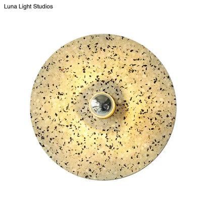 Modern circular terrazzo wall light in beige lake blue with speckled surface and polished chrome bulb holder for corridors