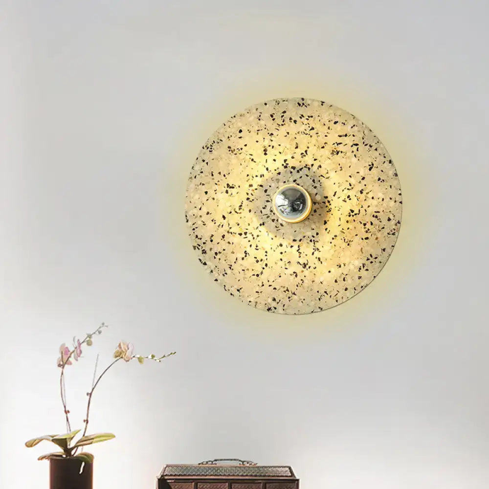 Modern circular terrazzo wall light in beige lake blue with speckled surface and metallic bulb holder for corridors