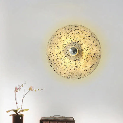 Modern circular terrazzo wall light in beige lake blue with speckled surface and metallic bulb holder for corridors