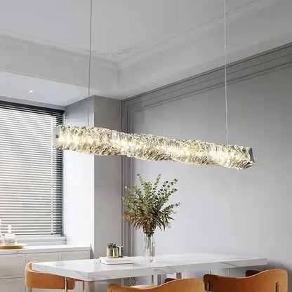 A modern circular textured crystal chandelier pendant light with a translucent glass body emitting warm illumination