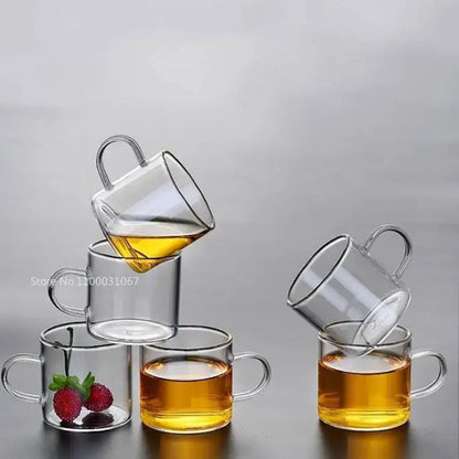 Modern clear 2pc 120ml glass handle coffee cup set with double-walled glass and curved handles, one cup with strawberries