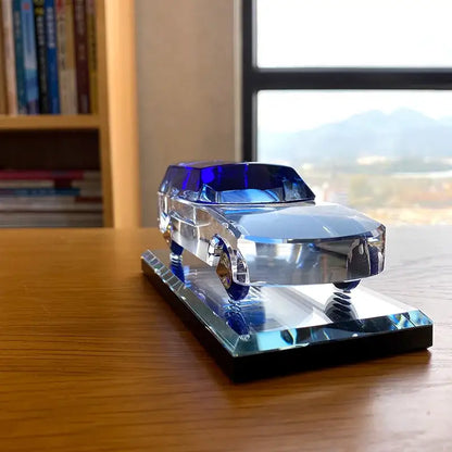 A modern clear and blue crystal car figurine with chrome accents on a crystalline base for living room decorbites crystal car
