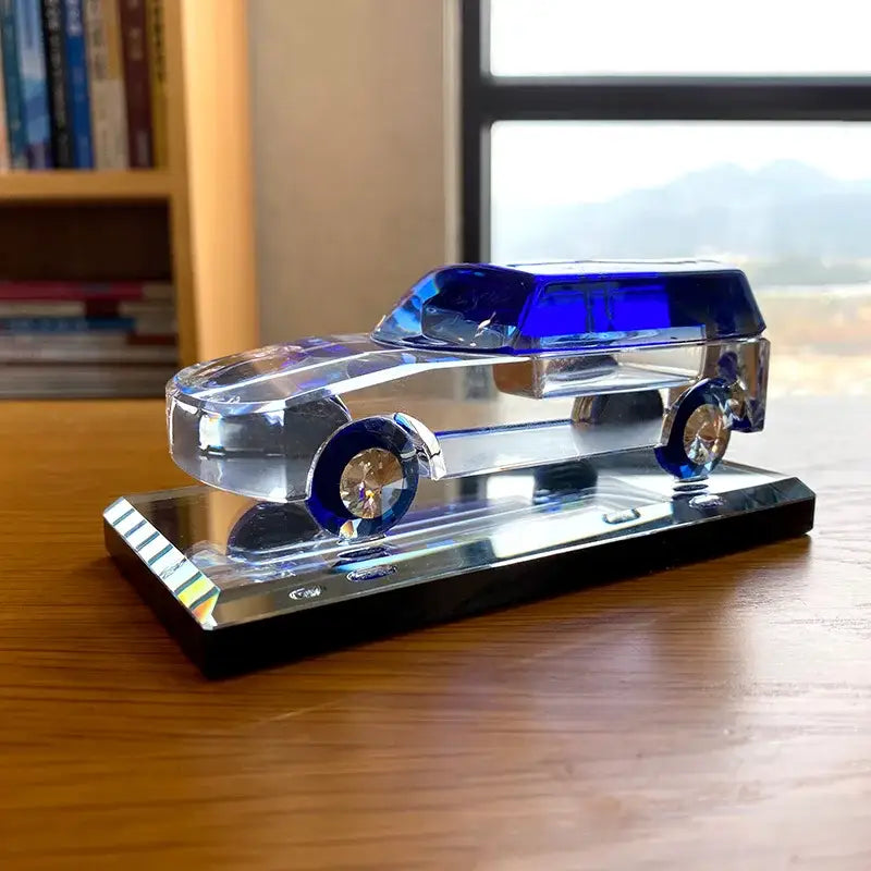 Modern clear and blue crystal car figurine with vibrant blue accents on a black base perfect for living room decorbites crystal car