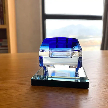 A sleek crystal car figurine with a transparent body and vibrant blue glass accents for modern living room decorbites decor