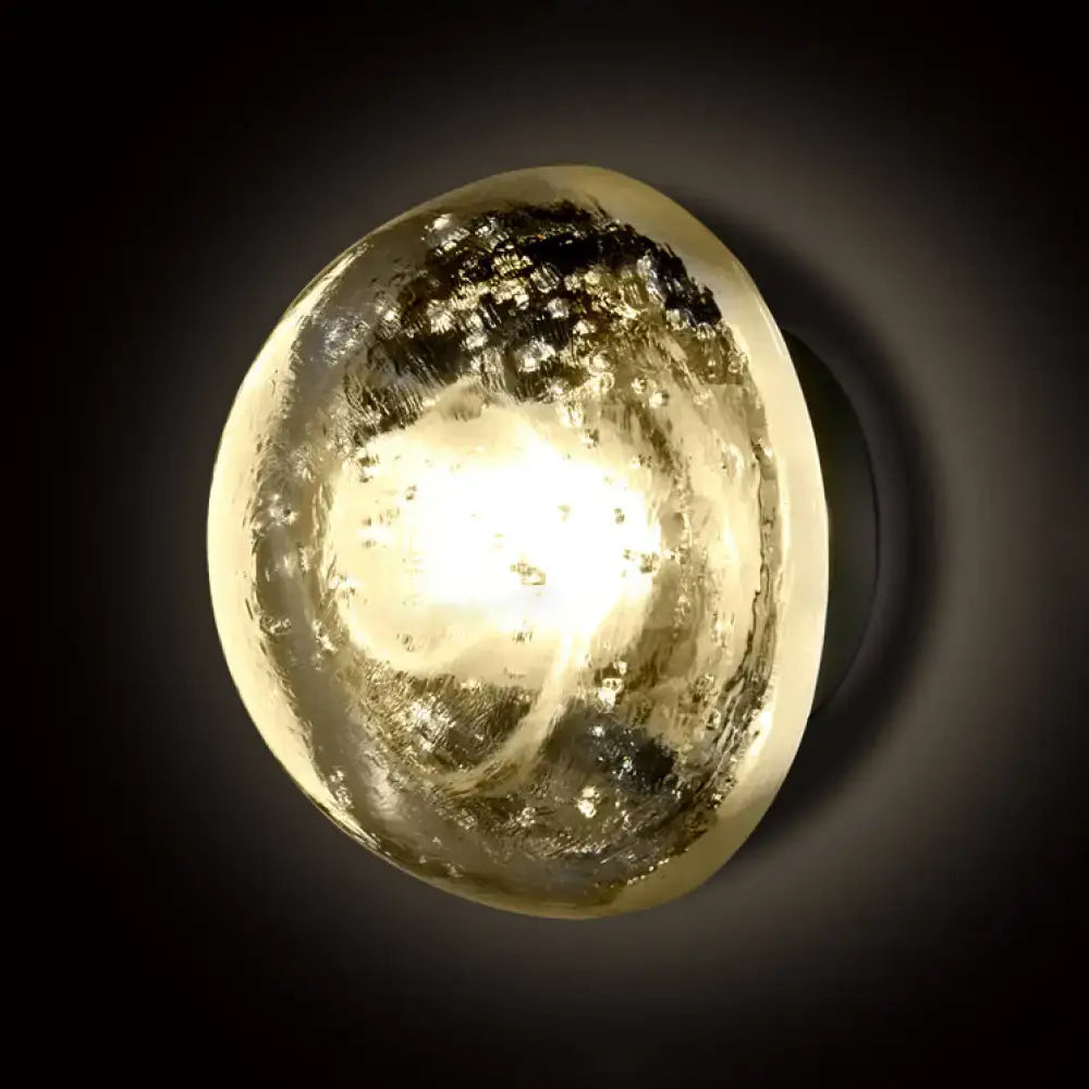 Modern clear bubble crystal wall light with translucent oval shape and warm white textured golden speckled surface