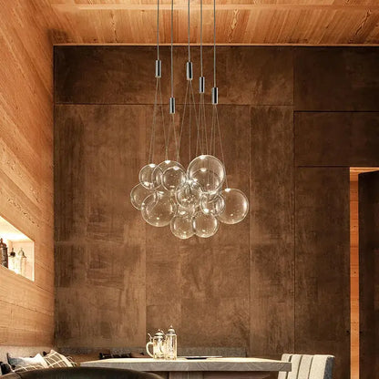 Modern clear bubble glass pendant light with clear spherical bulbs and sleek metallic rods for dining room decorbites bubble glass