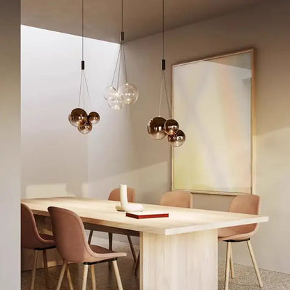 Modern clear bubble glass pendant lights with copper tones hang from the ceiling ideal for kitchen island decorbites bubble glass