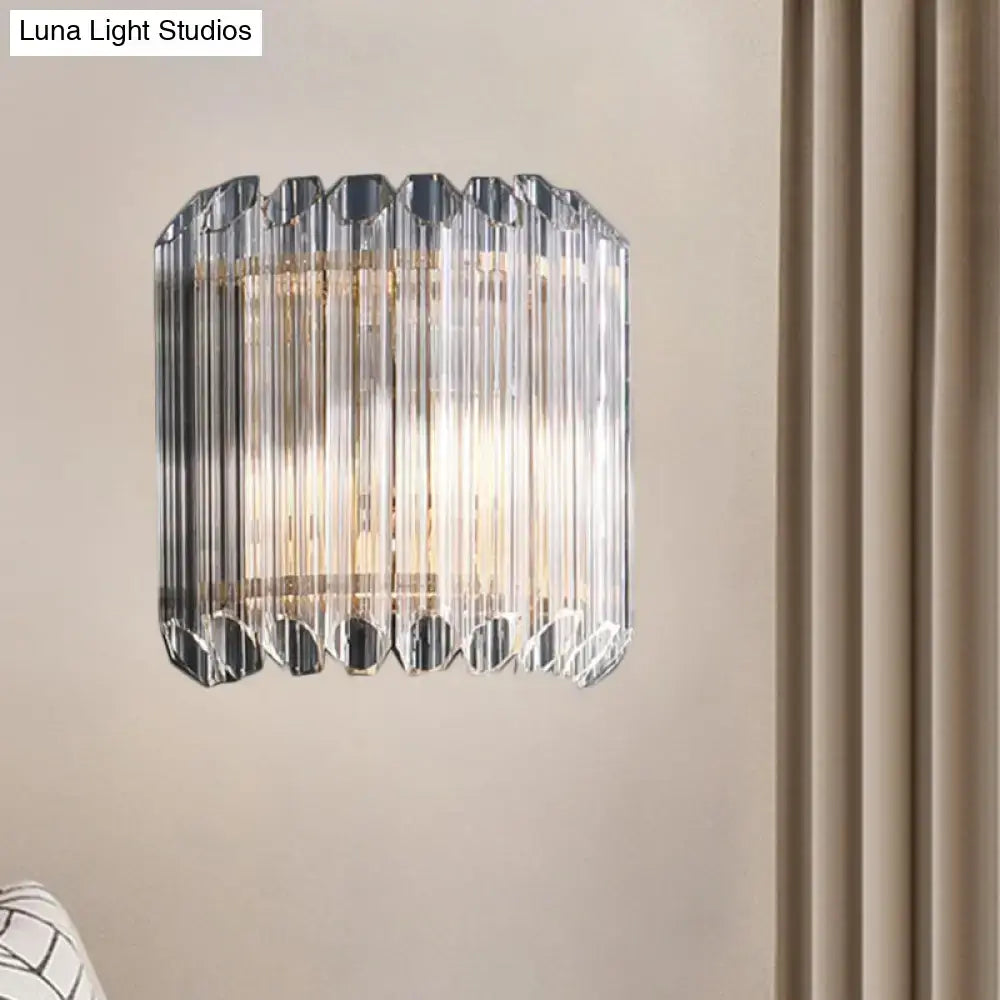 Modern clear crystal half drum bedroom wall sconce with faceted prismatic rods and sleek metallic frame light fixture