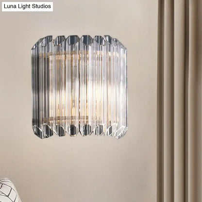 Modern clear crystal half drum bedroom wall sconce with faceted prismatic rods and sleek metallic frame light fixture