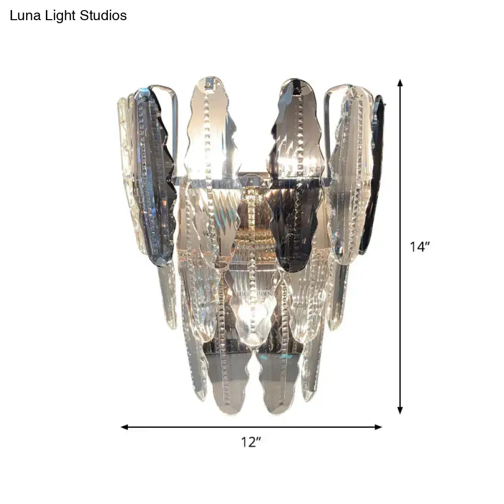 A modern 14-inch clear crystal and smoked glass wall sconce with polished chrome finish for living room lighting