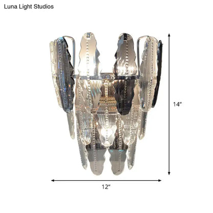 A modern 14-inch clear crystal and smoked glass wall sconce with polished chrome finish for living room lighting