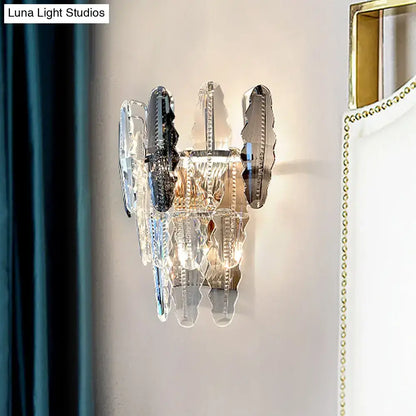 Modern clear crystal and smoked glass wall sconce with cascading mirrored and clear crystal shards for living room lighting