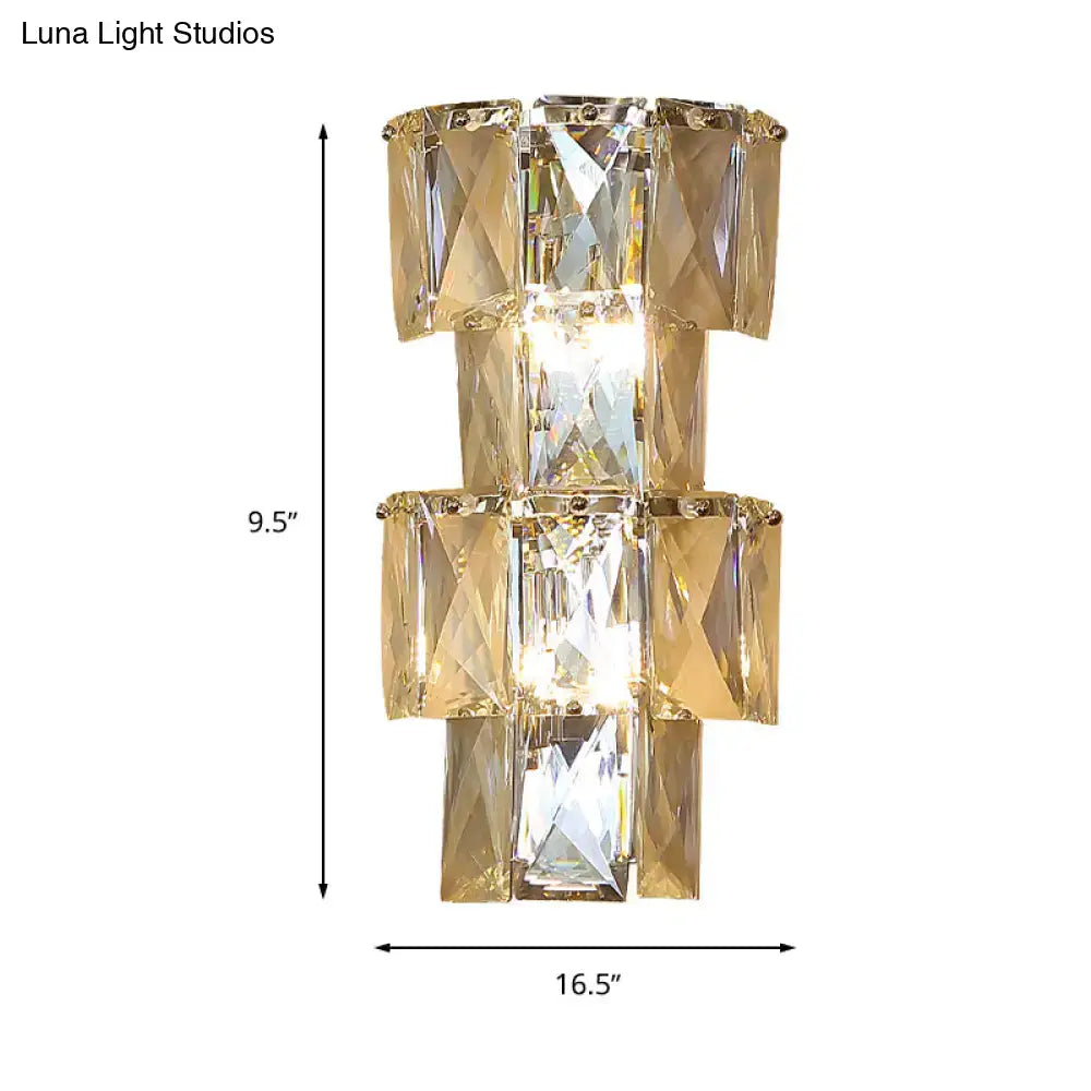 Gold-toned modern clear crystal tiered wall lamp with stacked rectangular facets in a bedroom chrome sconce lamp kit