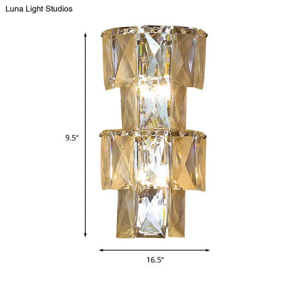 Gold-toned modern clear crystal tiered wall lamp with stacked rectangular facets in a bedroom chrome sconce lamp kit