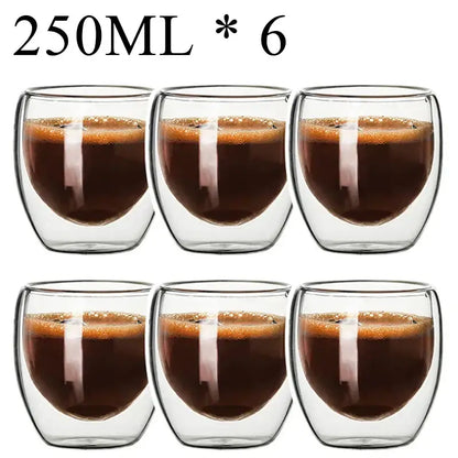 Set of six clear double wall borosillicate glass espresso cups filled with dark espresso and crema layer
