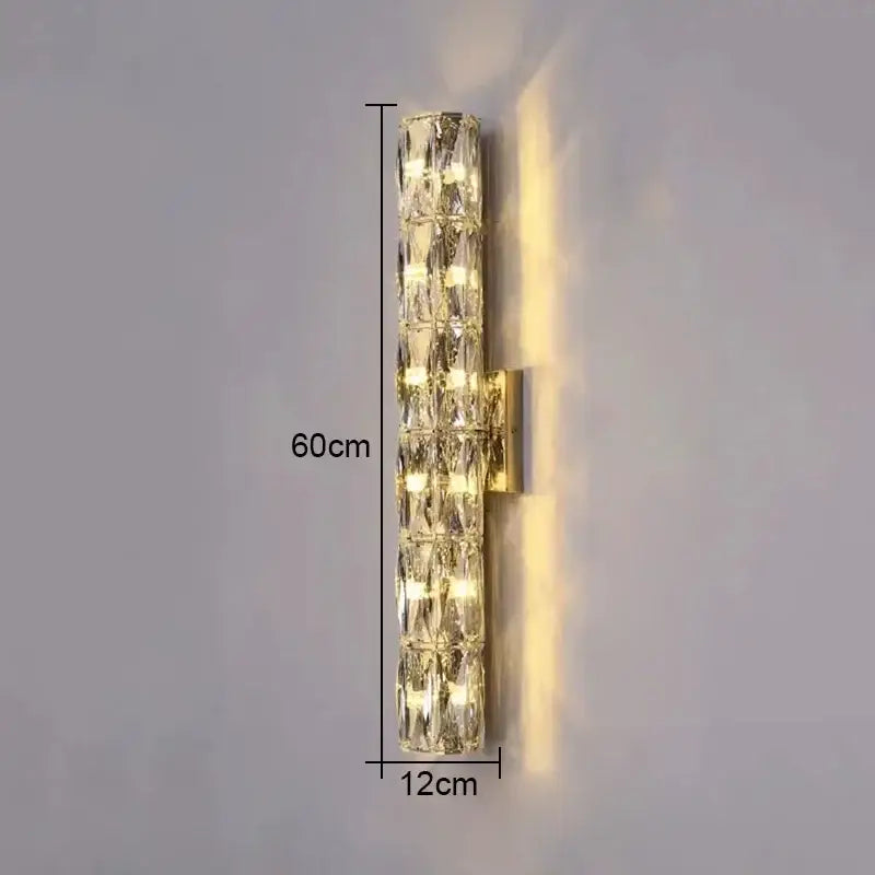 Modern wall lamp with clear faceted crystal segments in a gold metal frame by decorbites crystal high-end design