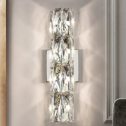 A modern clear faceted decorbites crystal wall lamp with silver metal backplate for luxury living room decorbites crystal high-end