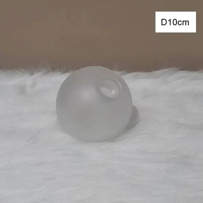 A frosted glass globe shade cover replacement with smooth translucent surface for modern living room lighting