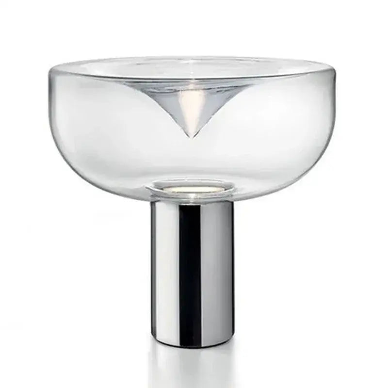 Modern clear glass aella table lamp with sleek chrome base and triangular cutout for bedroom or office decorbites aella