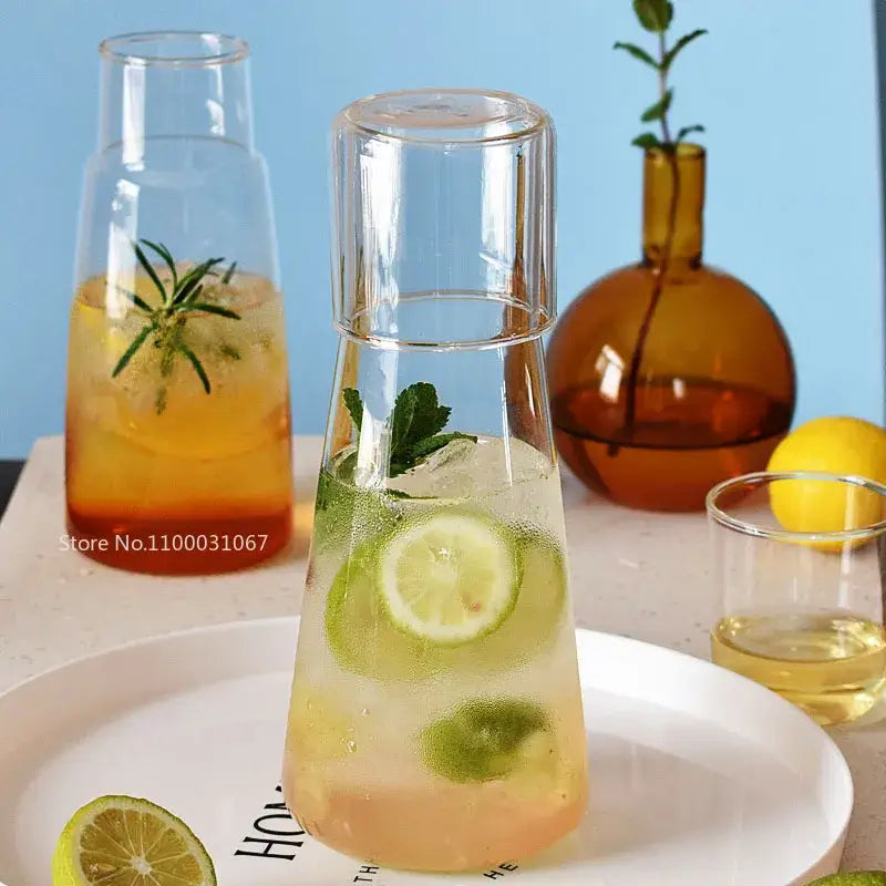 Modern clear glass bedside water carafe set with matching lid filled with ice and lime slices for bedroom decorbites clear glass