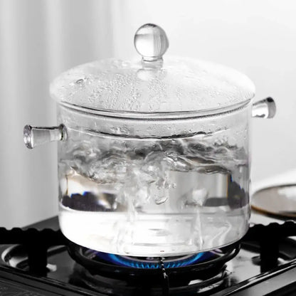 Modern clear glass cooking pot with silver rounded handles and lid knob ideal for boiling water and glass cooking tasks