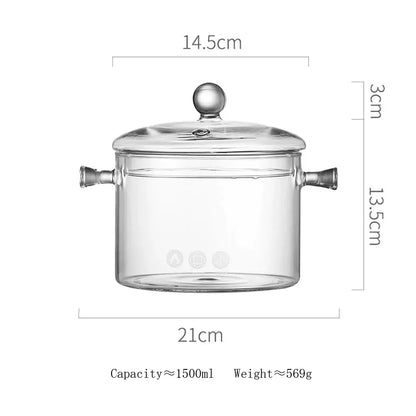 Modern clear glass cooking pot with silver handles and matching lid featuring a rounded knob for glass cooking use