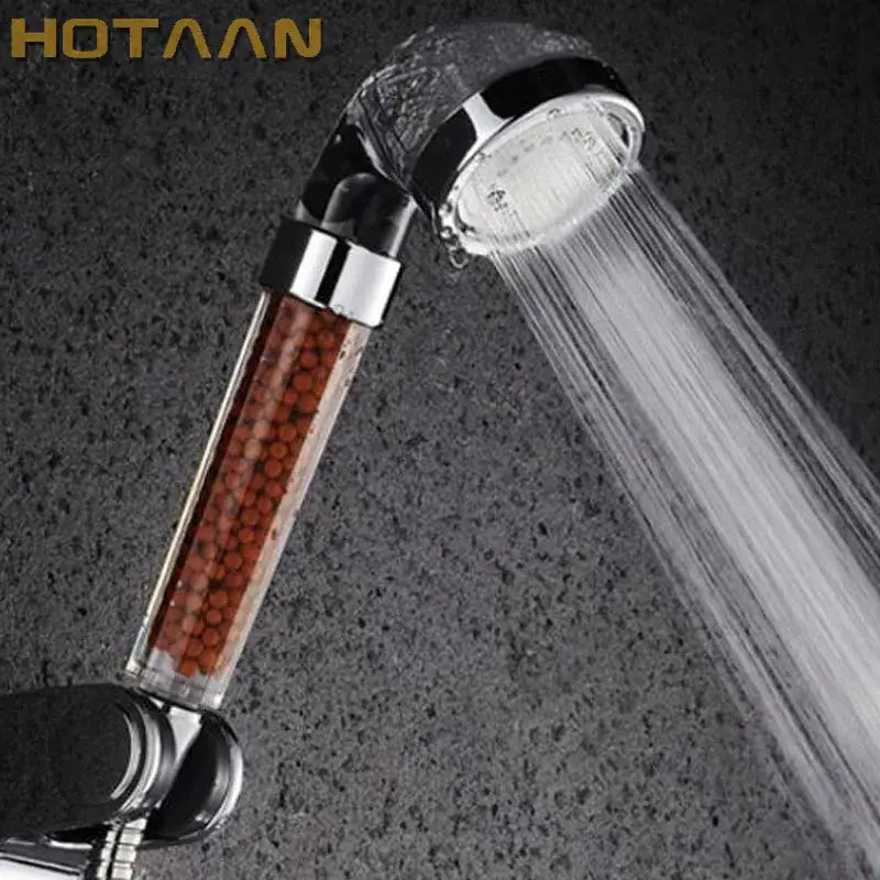 Hotaaan modern clear glass crystal anion handheld shower head with transparent body and reddish-brown filter beads chrome nozzle