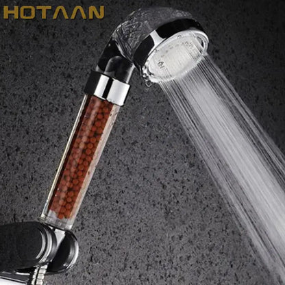 Hotaaan modern clear glass crystal anion handheld shower head with transparent body and reddish-brown filter beads chrome nozzle