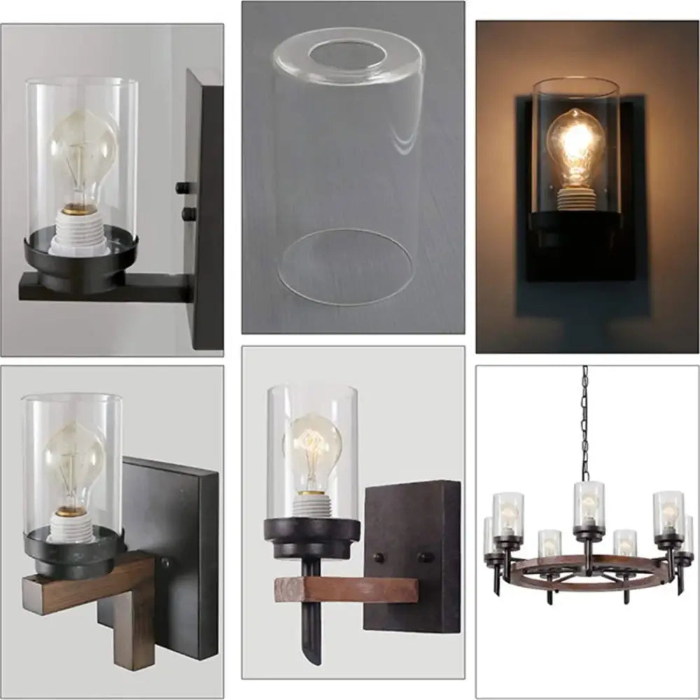 Black metal wall sconce with decorbites clear glass cylinder housing an exposed edison bulb for bathroom vanity light
