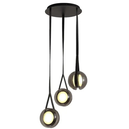 Modern black pendant lights with three clear glass spherical shades emitting warm glow for bedroom decorbites designer pendant