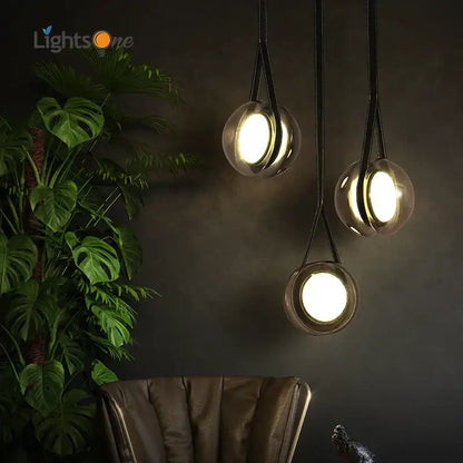 Three modern clear glass pendant lights with black fabric cords from decorbites designer pendant lights collection